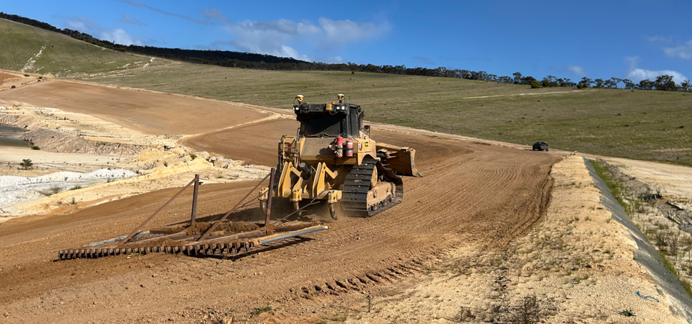 Loader machine performing repair works on slode of an old mine pit